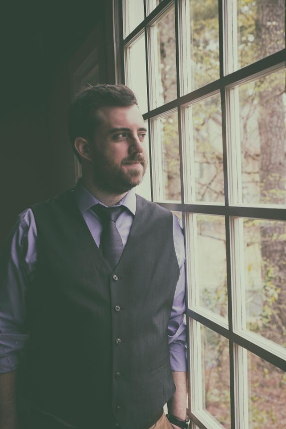 Groom looking out window