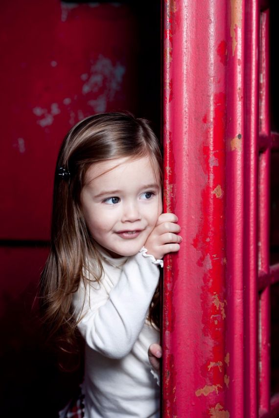 child peeking around corner